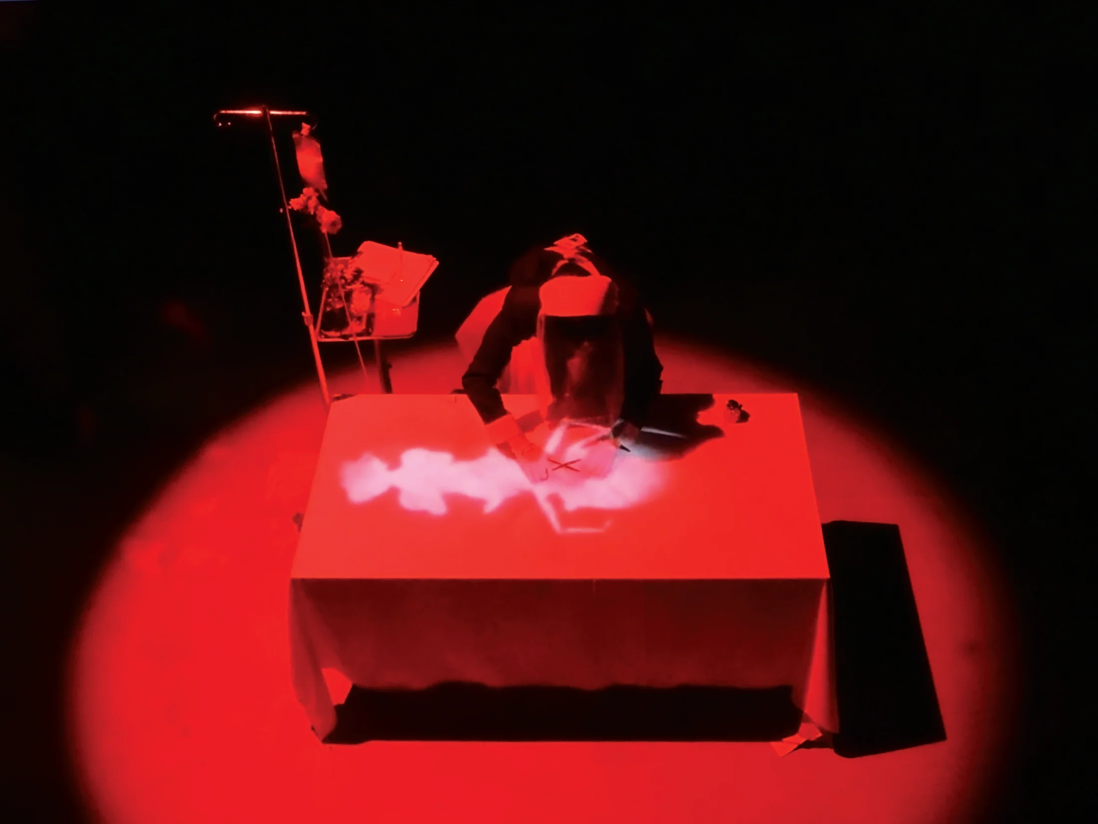 Red-lit performance with a projected body